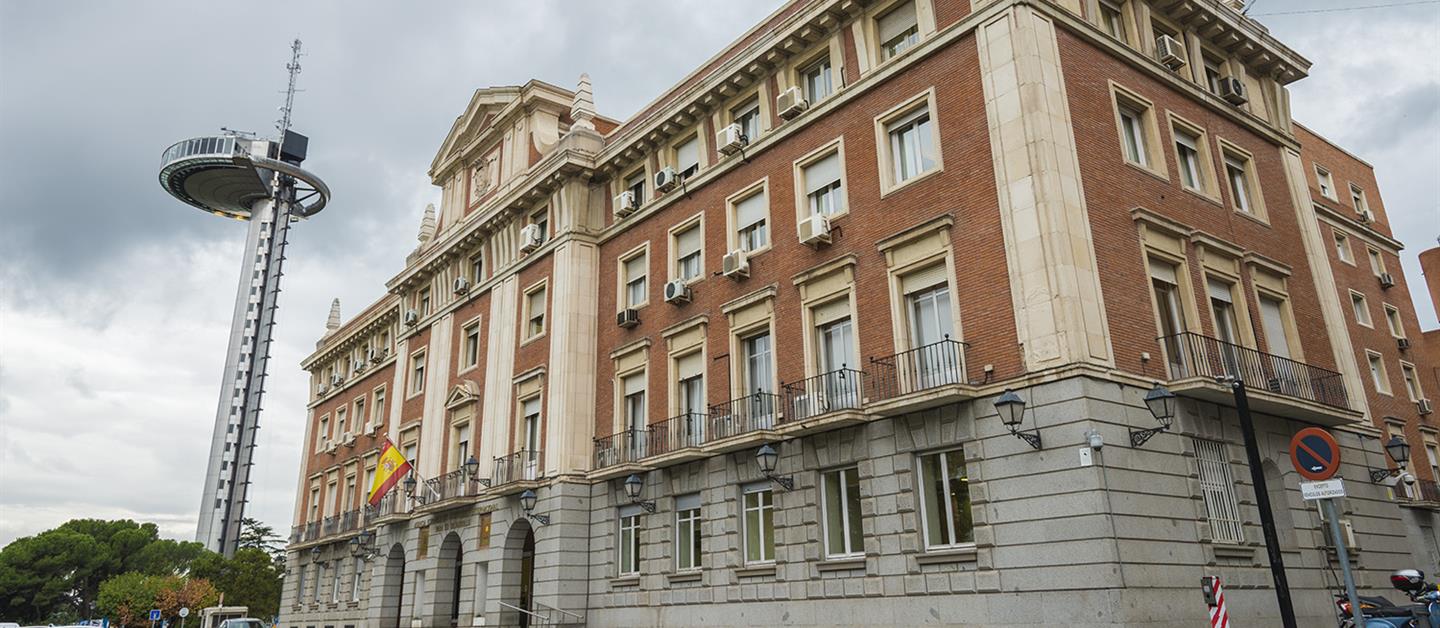 Fachada de la AECID, con el Faro de Moncloa al fondo